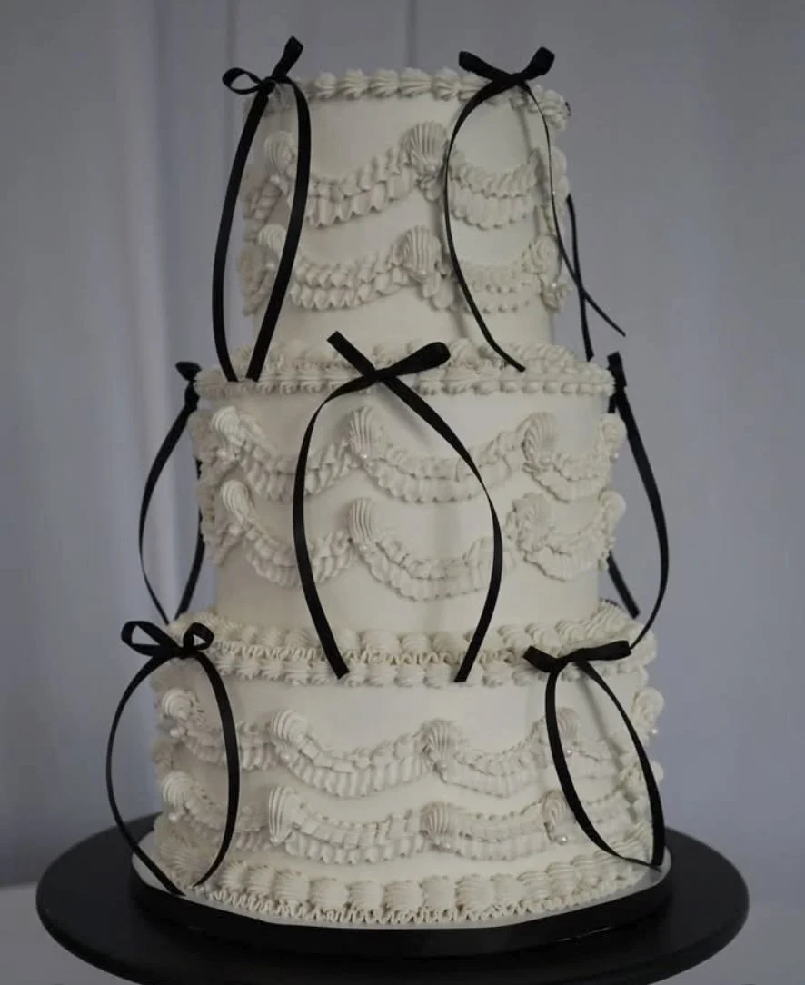 Vintage piped cake with black bows by Citrus Blossom Bakery