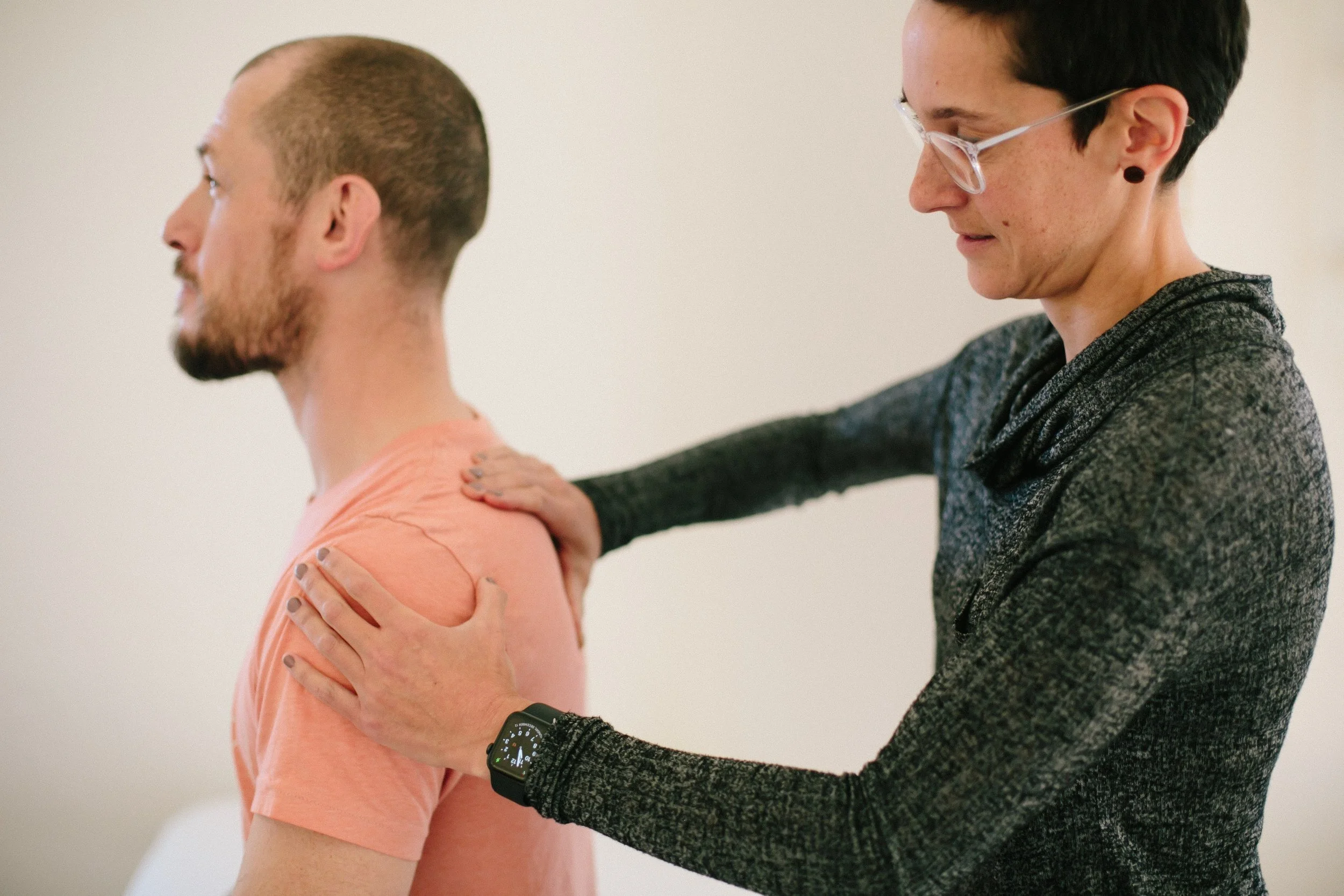 A picture of a physical therapist providing orthopedic therapy for a male patient. Working on shoulder mobilization.
