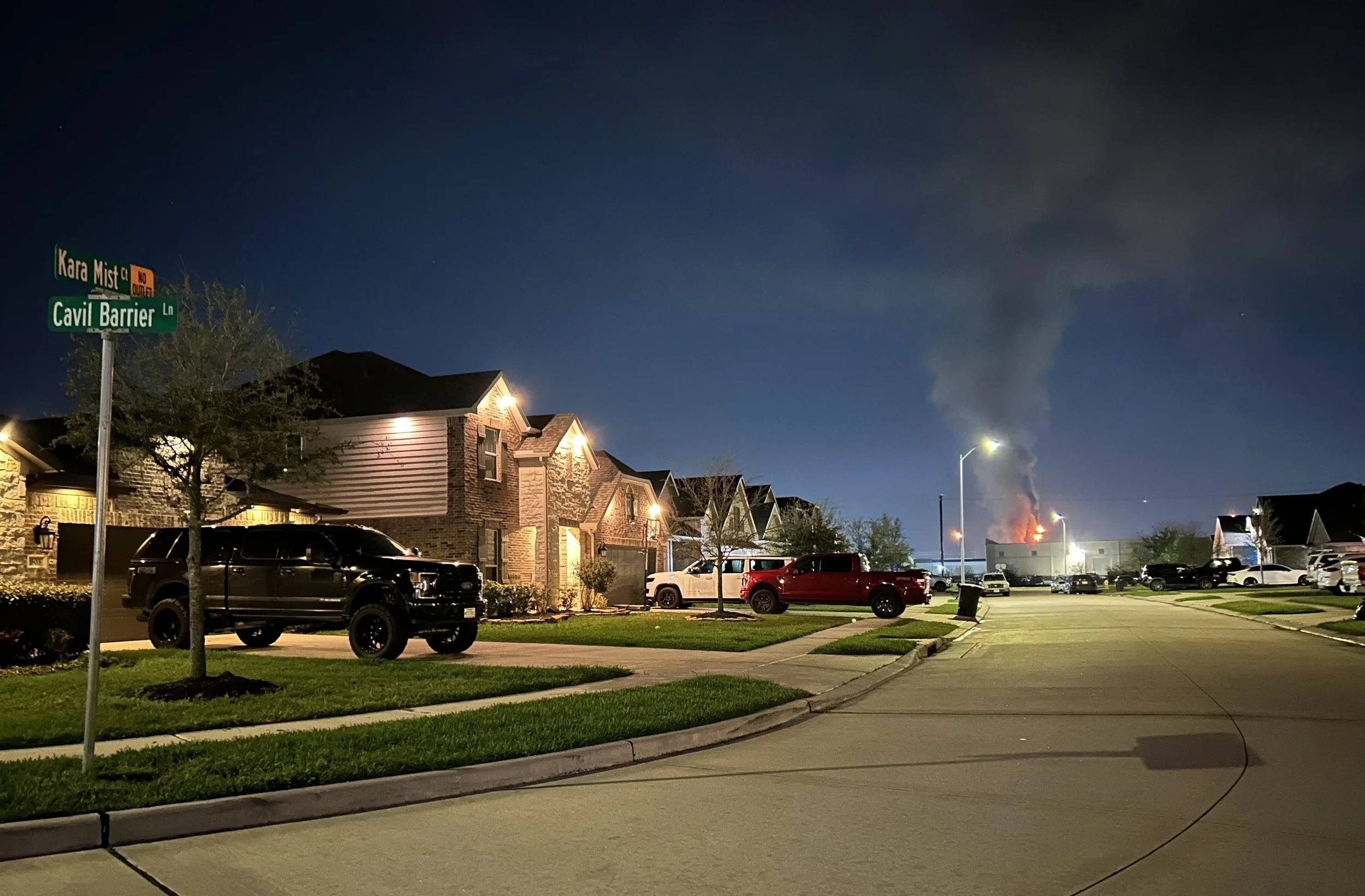 A fire at a chemical facility is directly behind a neighborhood