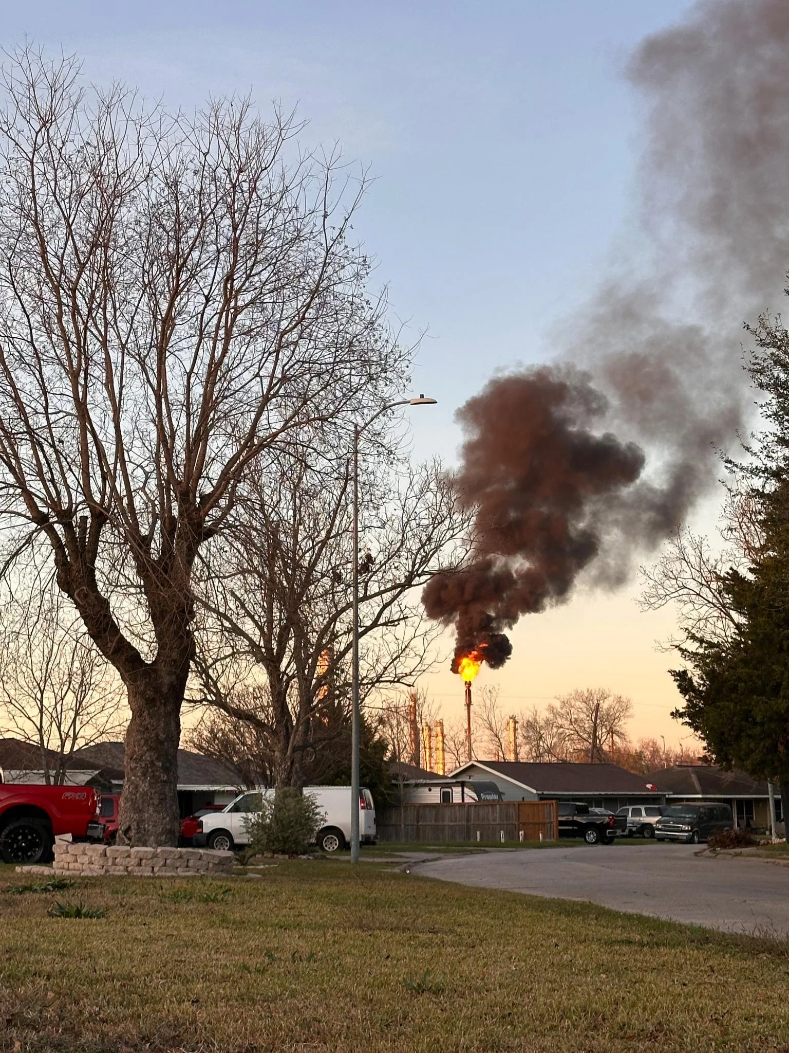A large flare can be seen behind a neighborhood