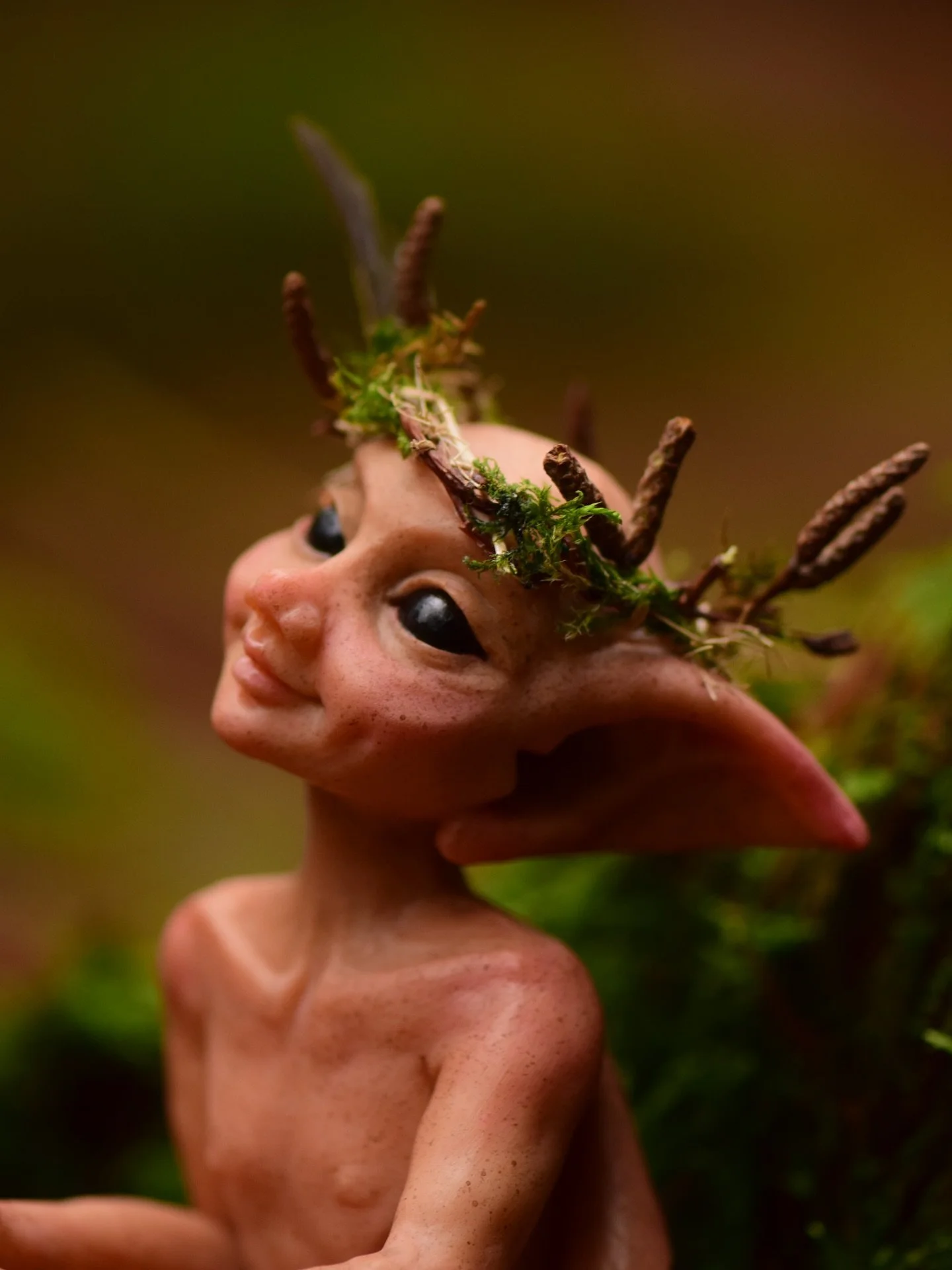 The beautiful Pixie A&iacute;bell (pronounced Ay-vull) who wears a crown of willow and moss, It is both adornment and symbol, a mark of belonging to the woodland that she came from 🖤
You can meet A&iacute;bell and other Forest Children at the Glasto