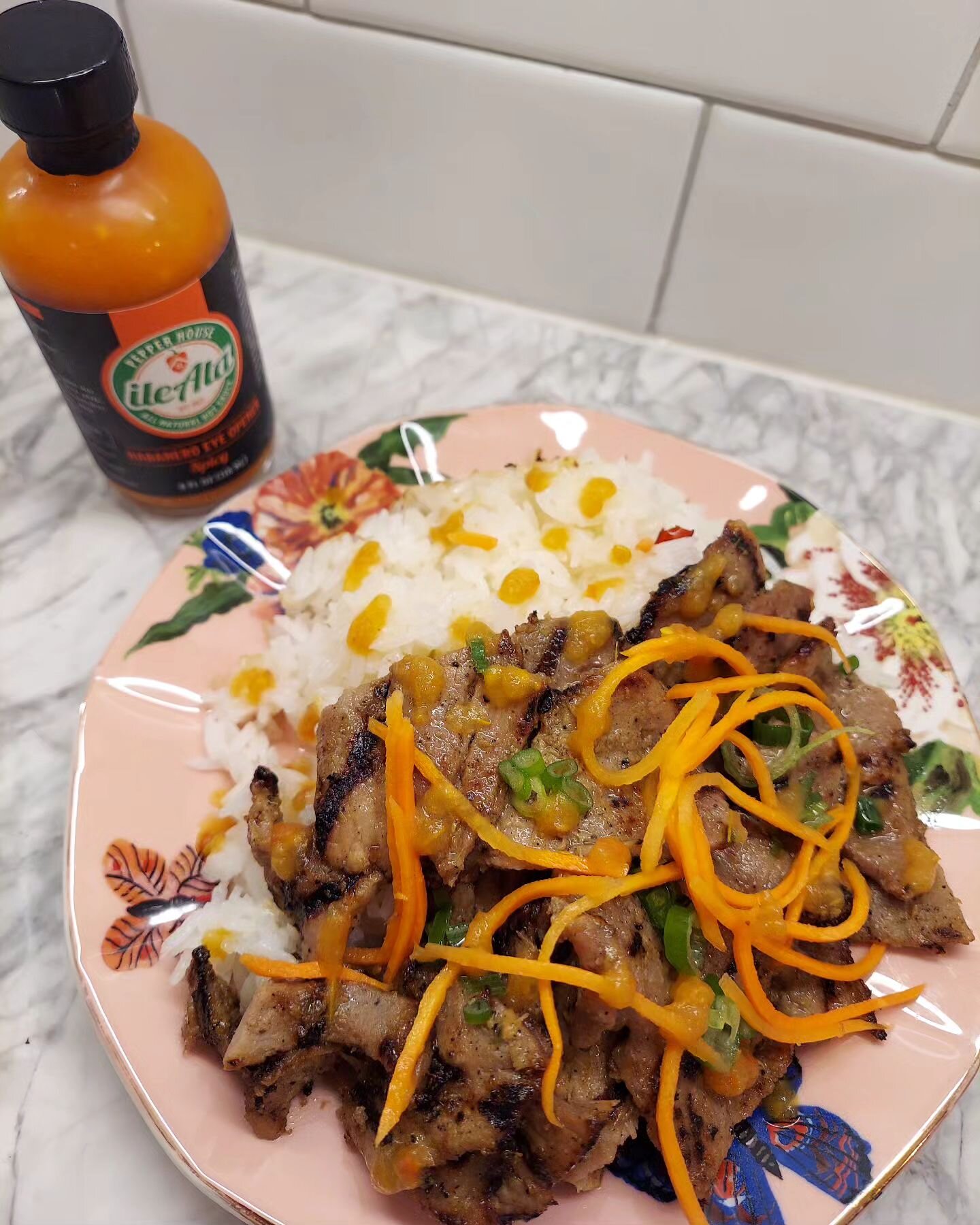 Grilled pork over rice gets some major heat and flavor with our hottest sauce: Habanero Eye Opener Spicy. #OrangeHotSauce #Spicy #SpicyHotSauce #FlavorUpgrade #FlavorWithAKick #HotAndSpicy #PorkAndRice #PorkOverRice #GrilledPork #HotSauce #HotSauceFo