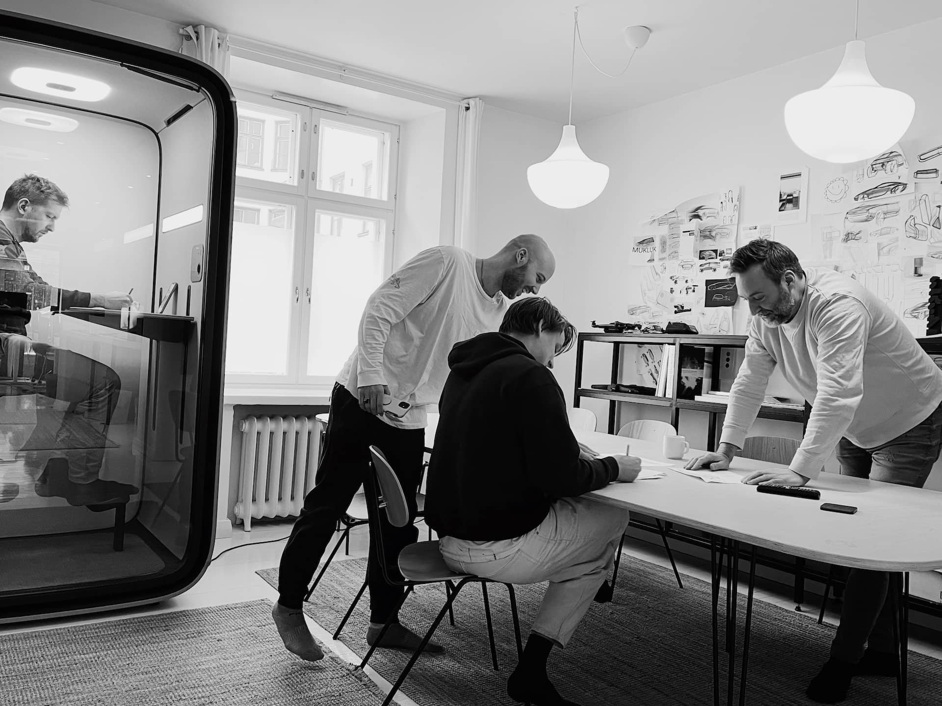 A team of designers collaborating at a table to design products and creating design strategy