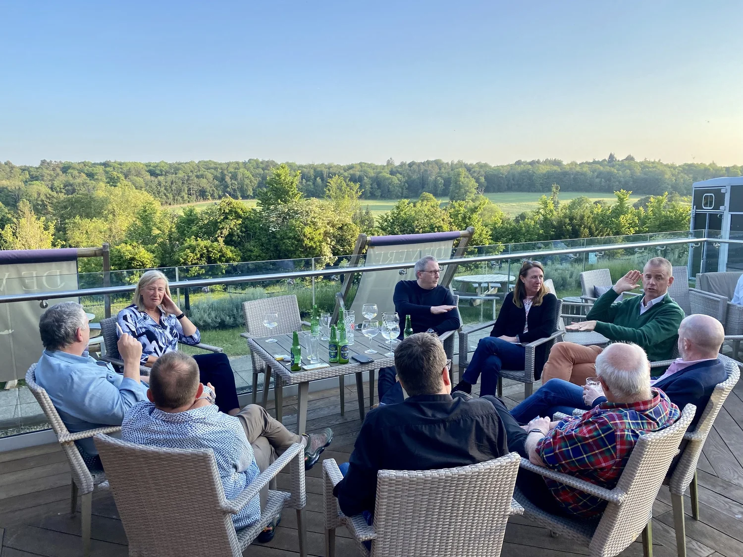 Progressive Leaders group in conversation on a terrace at a goals retreat