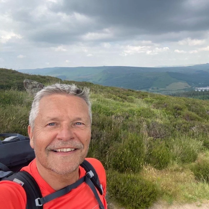 Glenn Watkins outdoors on a hillside