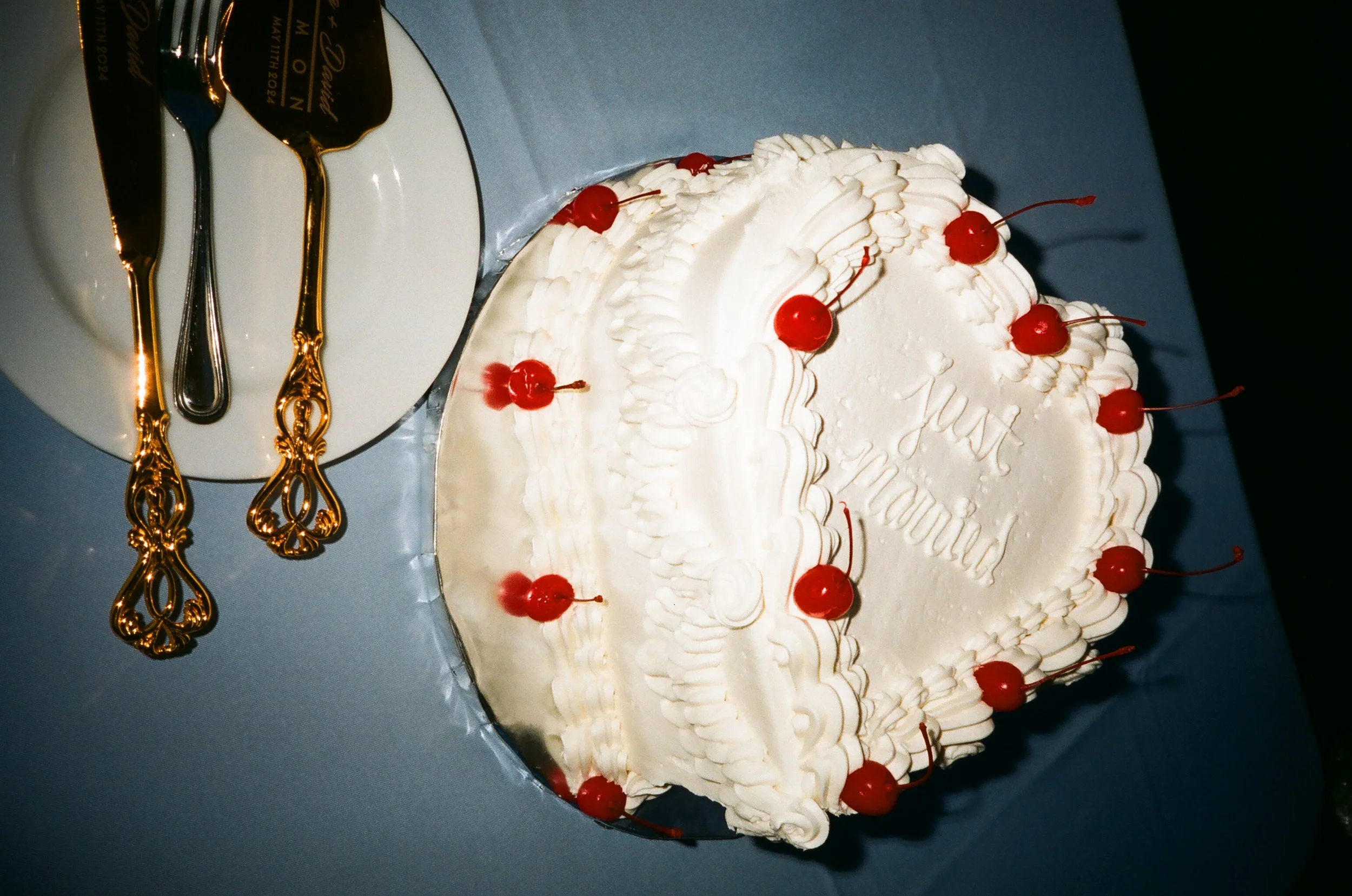 Vintage heart shaped wedding cake with cherries photographed on 35mm film by a Long Island wedding photographer.