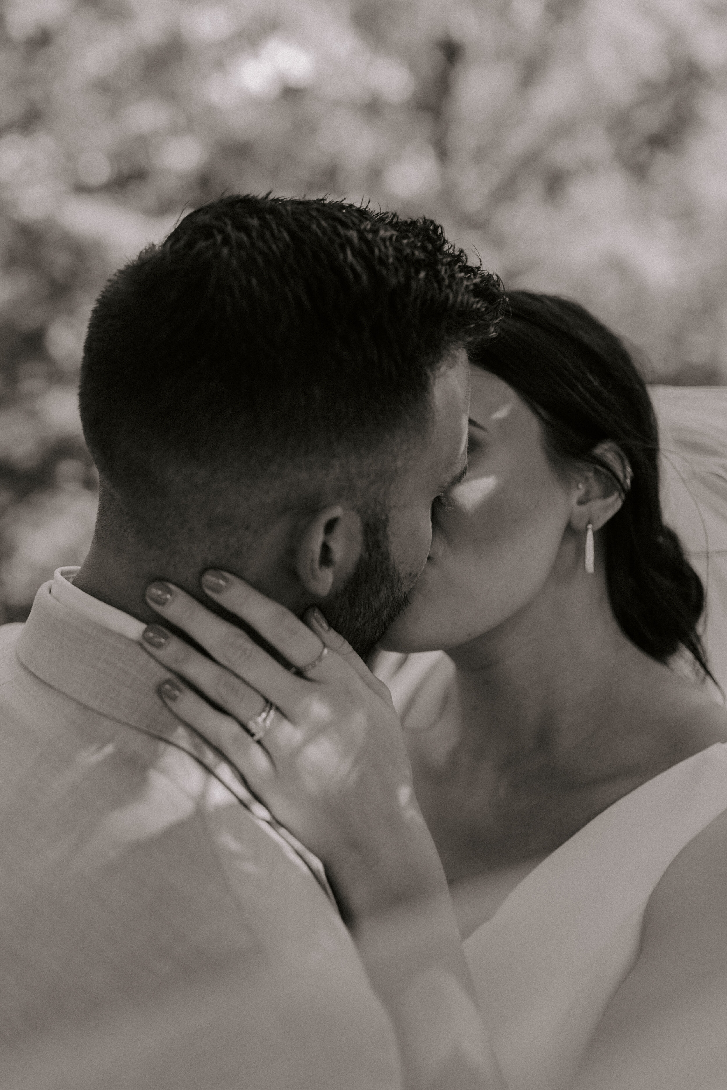 A couple sharing an intimate close-up moment, facing each other with their heads touching.