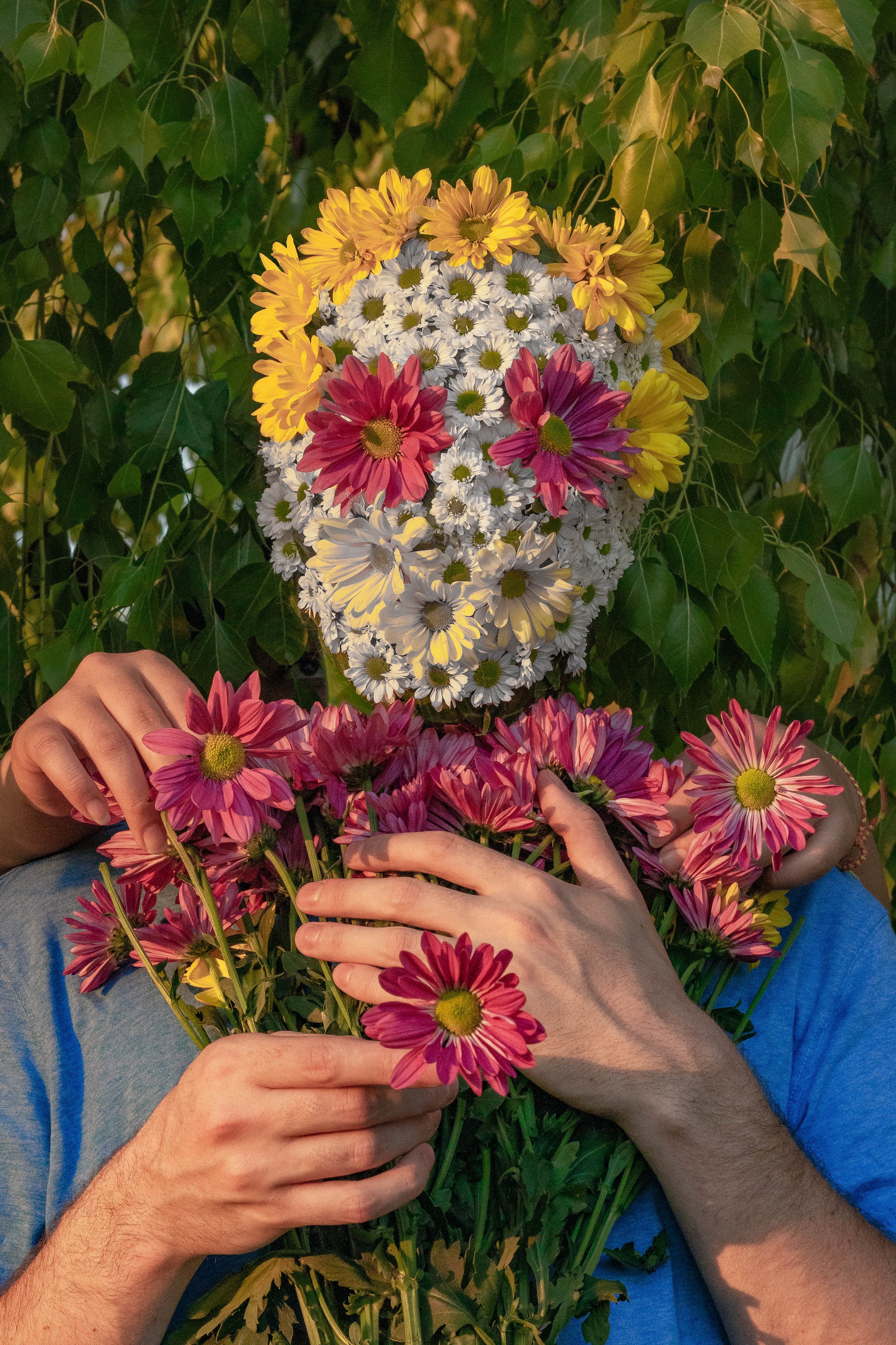 Image of a man with a flower face holding a bouquet of flowers