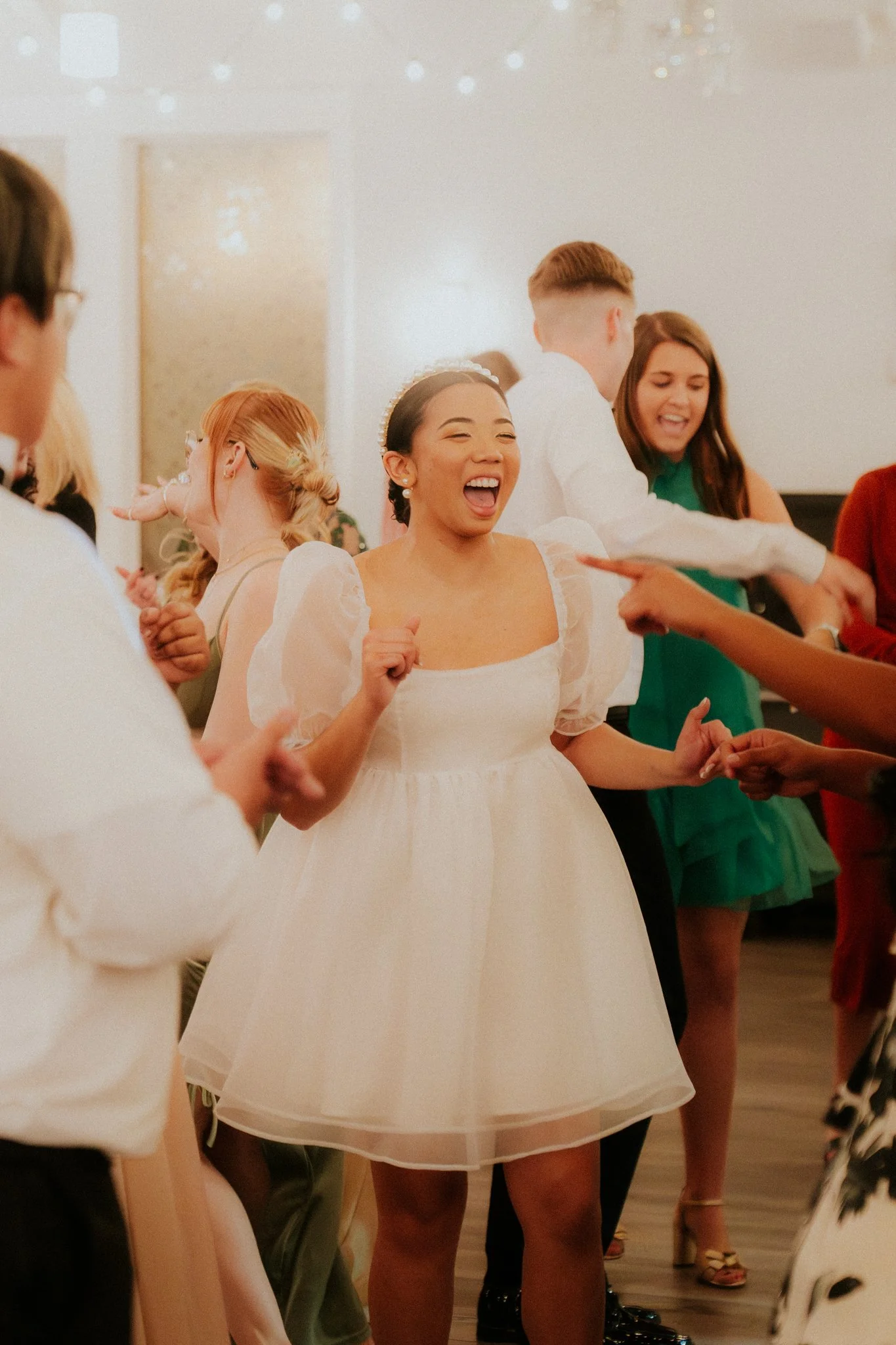People dancing and celebrating at a wedding reception.