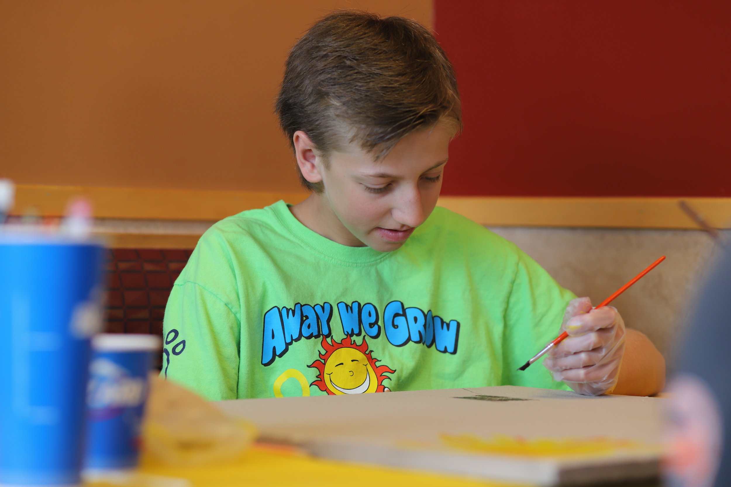 Corbin painting his tile at DQ