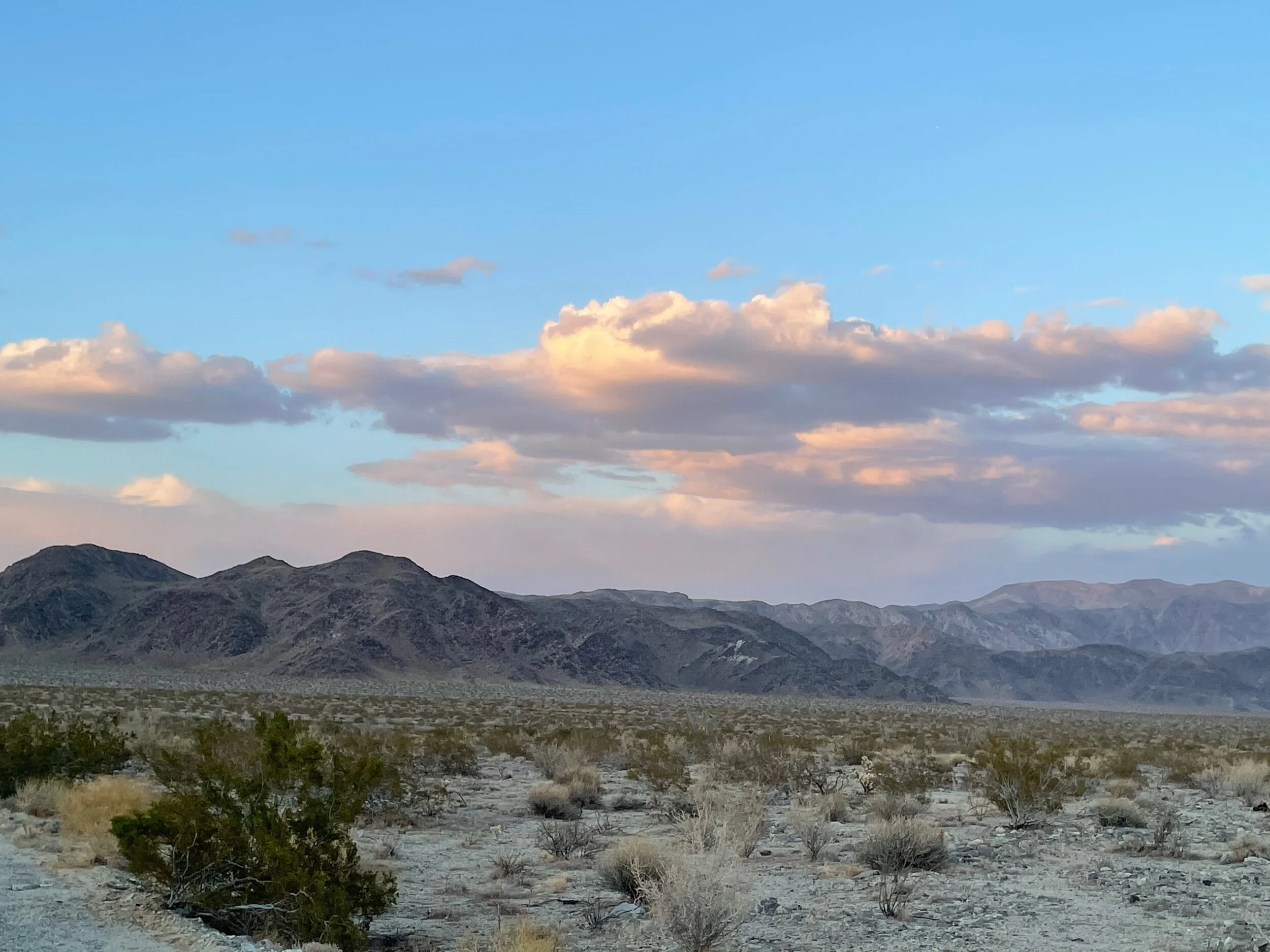 Sunset behind us throwing pink on the clouds
