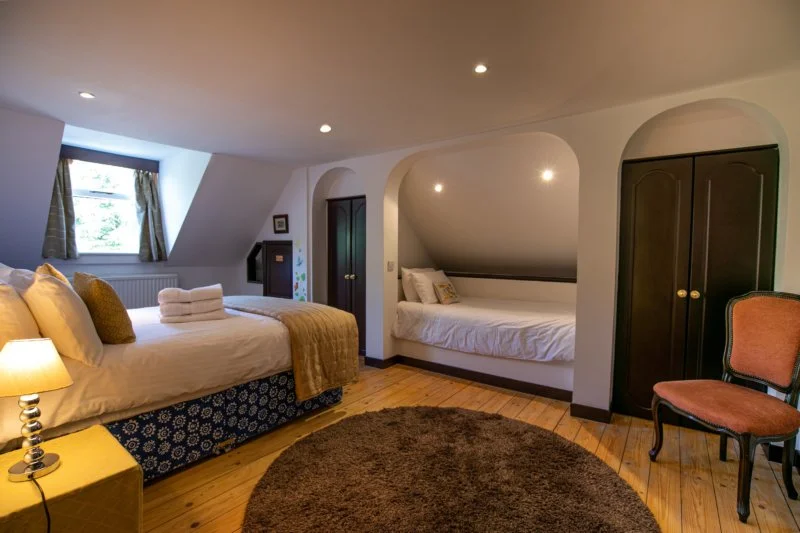 HIDEAWAY

A larger room with one double bed and one single. It has a private bathroom with a bath.