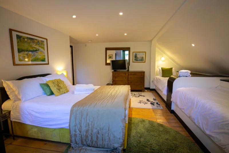 BLUE ROOM

The Blue Room sleeps 4 people, with one double and two single beds.

Bright and colourful, it has a private bathroom with a bath.