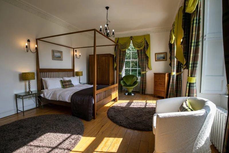 HIGHLANDS

The master bedroom of the house. A huge room, with a four poster and tartan theme.

The vast bathroom has painted murals on the wall and features a two seater bath and built in shower.