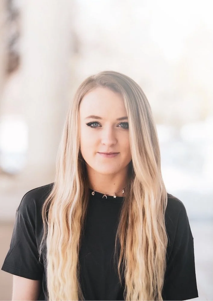 a blond teenage girl wearing a black shirt