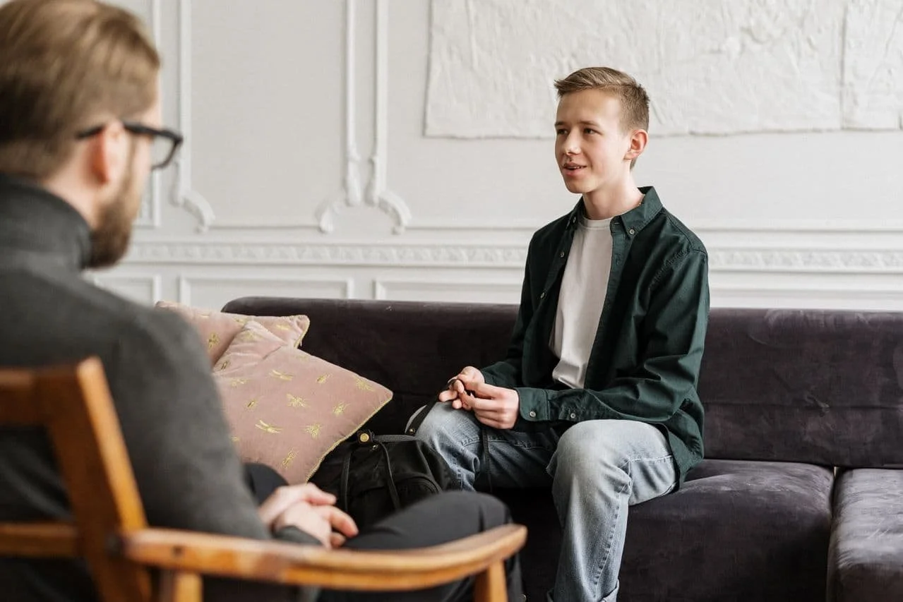teen boy talking in therapy