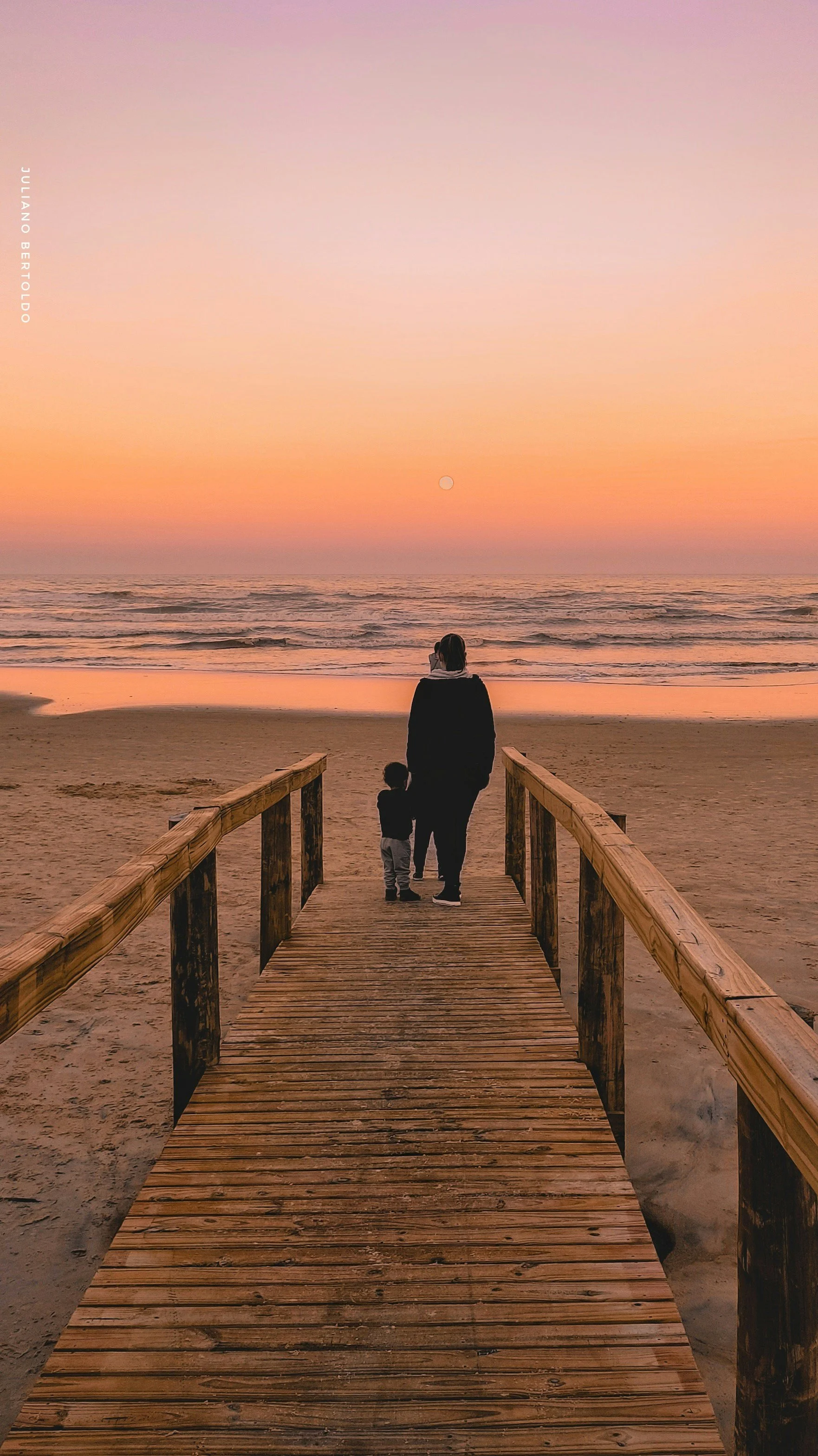 Adult and child walking down a wooden boardwalk to the beach at sunset, symbolizing connection, empathy, and emotional intelligence in relationships.