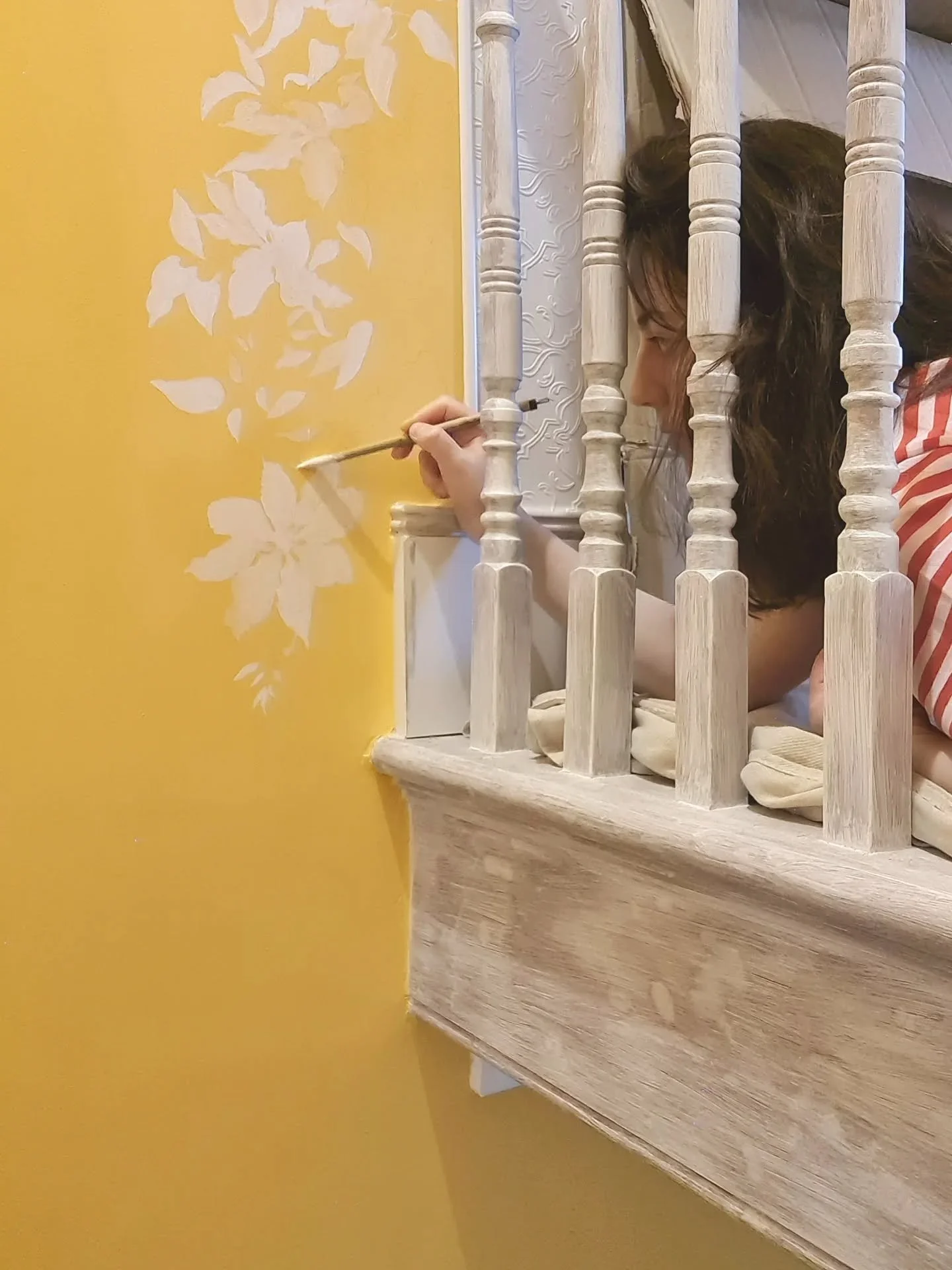 A rather awkward space to paint at the top of the landing, but still great fun! Fortunately, I could reach some of the lower flowers from the stairs. 

As you can see, the bannisters here are also in the middle of being painted.