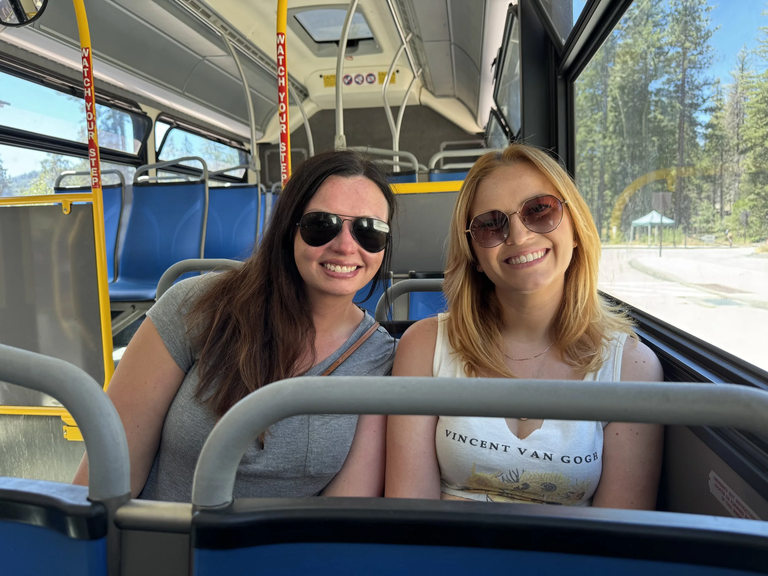 Young women smiling while riding the Yosemite Valley shuttle