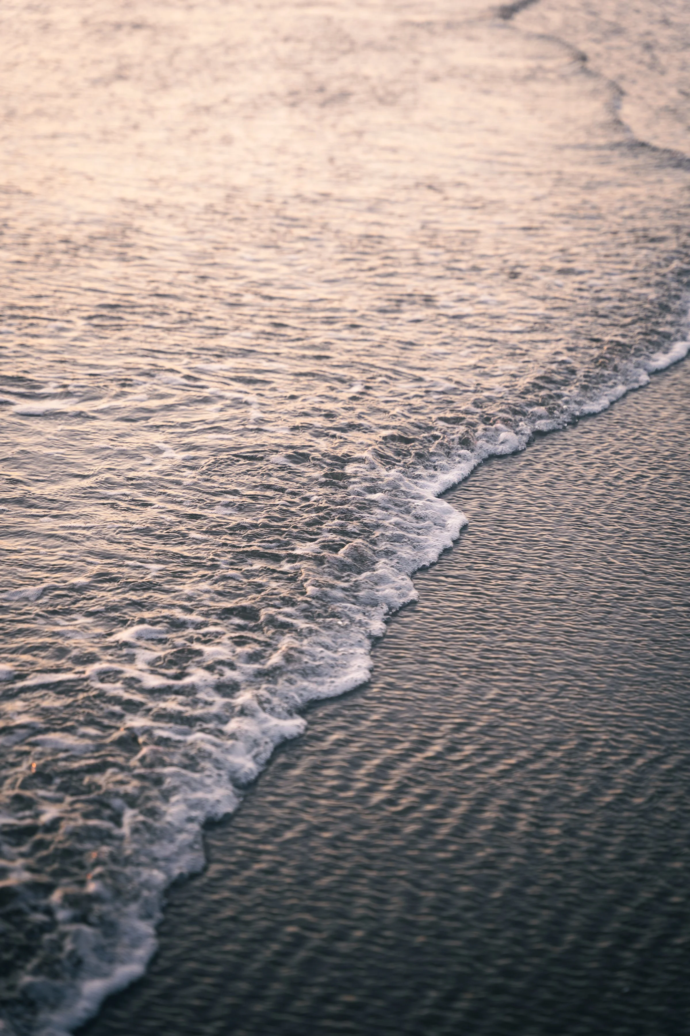 Close-up of ocean waves at sunset or sunrise