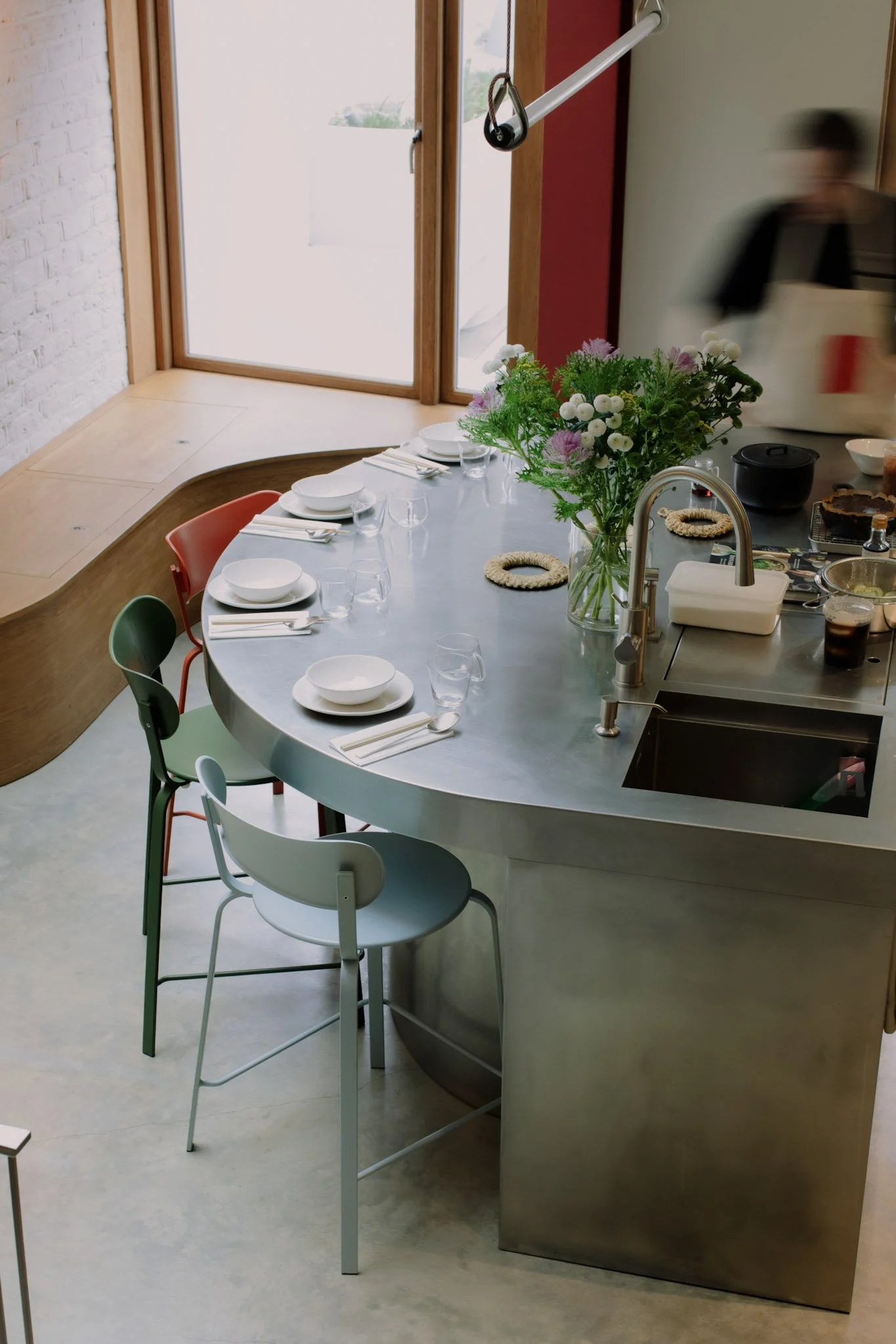 A Curved stainless steel kitchen island for Zac and Hilary