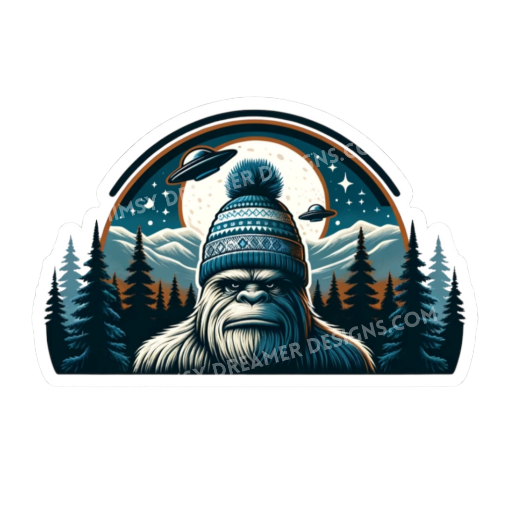 Winter Bigfoot UFO sticker with a beanie-wearing Sasquatch in a mountain forest under a full moon and two flying saucers