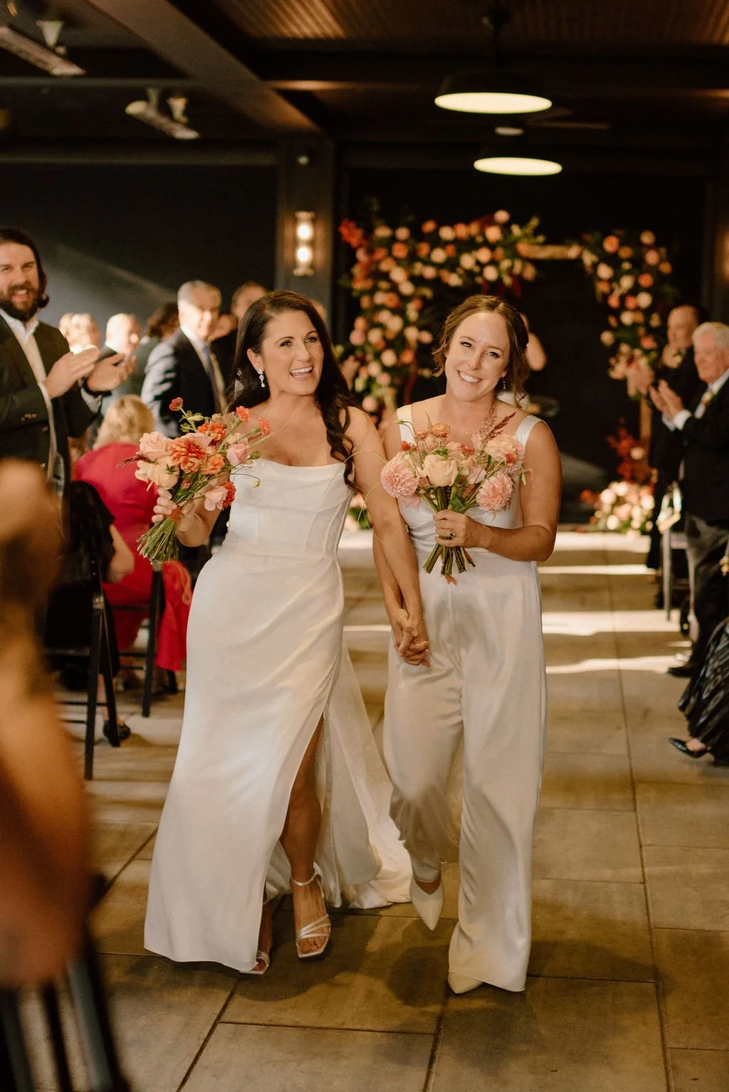 happy brides exiting the wedding ceremony