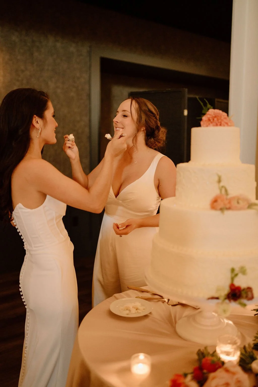 brides cutting cake during their ivy at the ellis preserve wedding reception