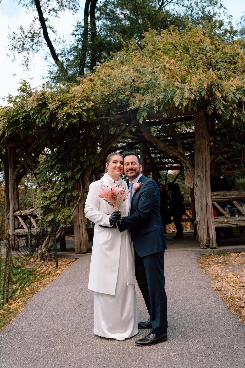 sweet couple hugging during their central park elopement during fall