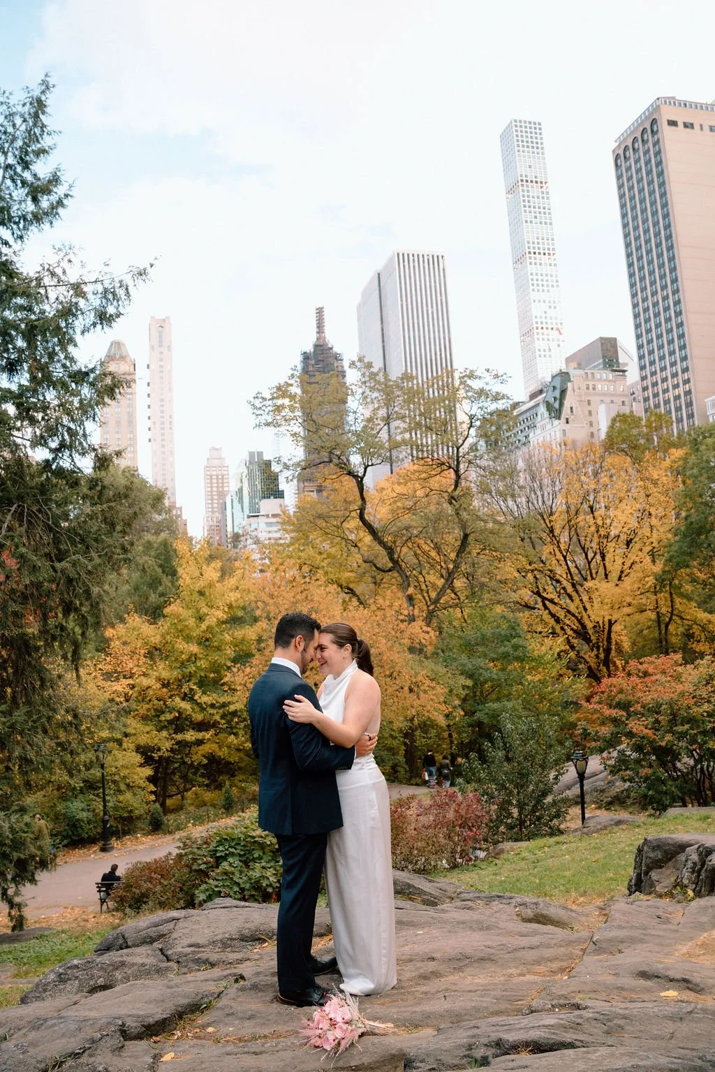 sweet couple hugging during their central park elopement during fall