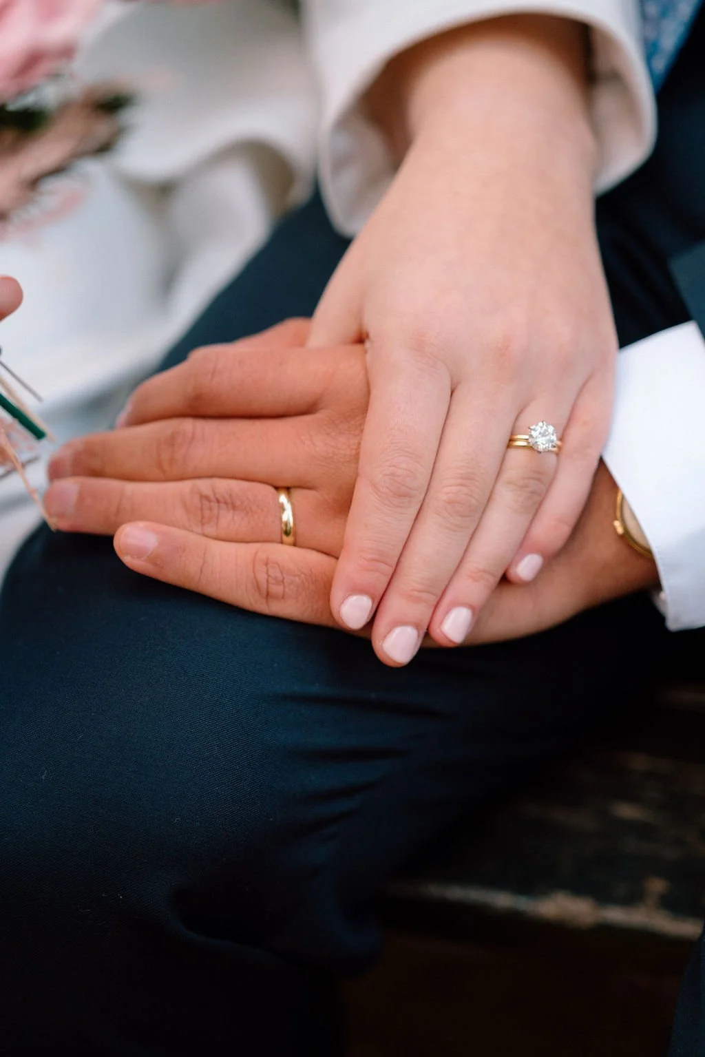 close up of wedding couple showing off rings