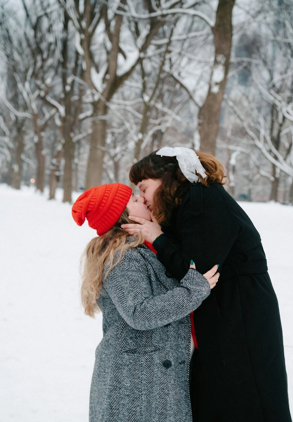 playful lesbian engagement photos in the snow at central park
