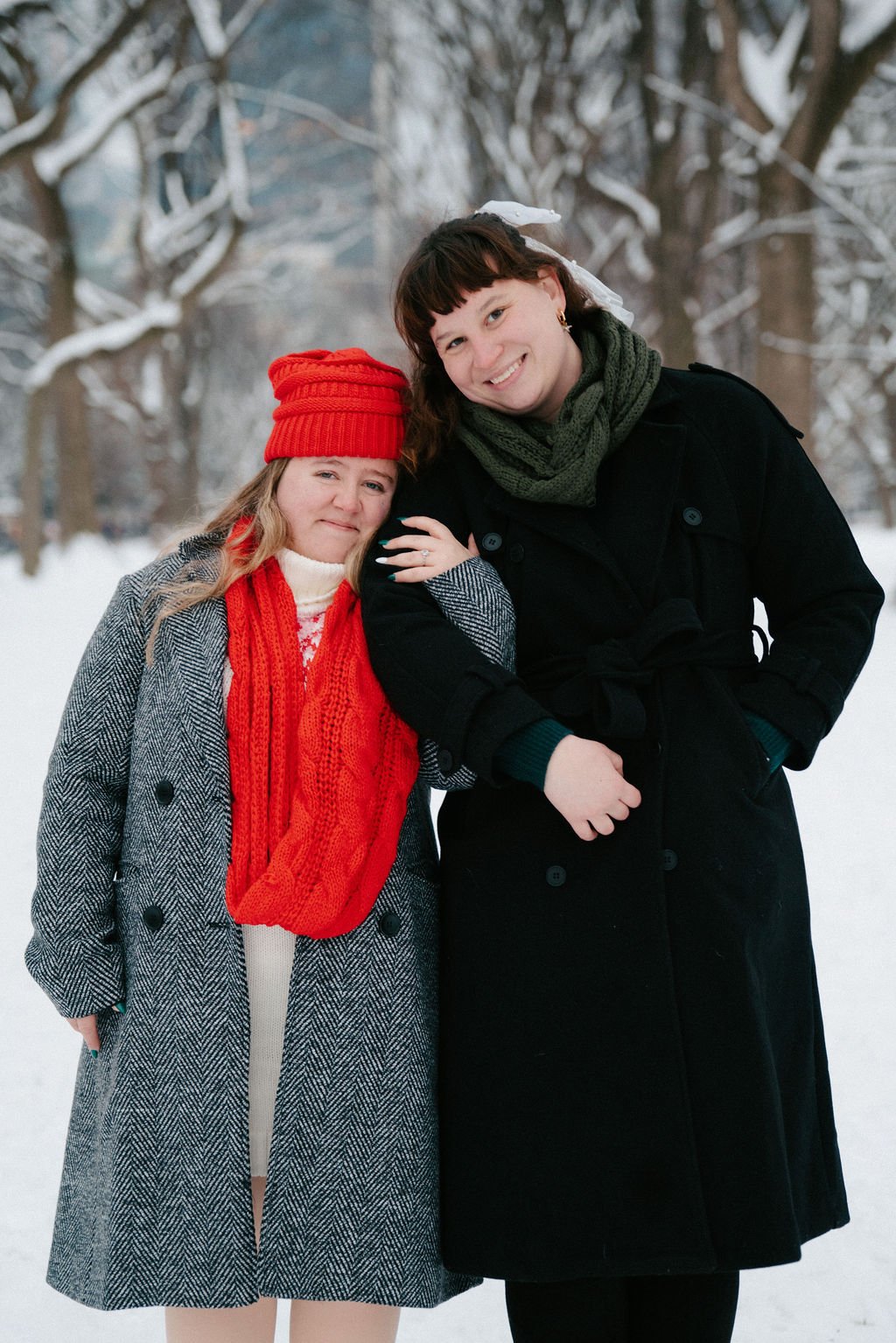 playful lesbian engagement photos in the snow at central park