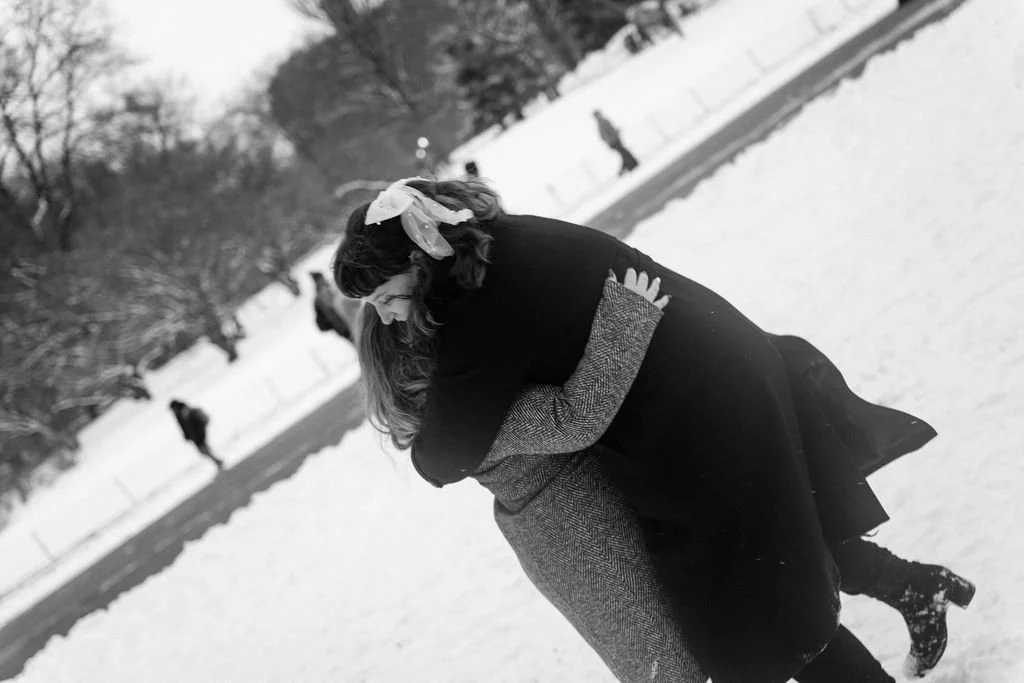 playful lesbian engagement photos in the snow at central park