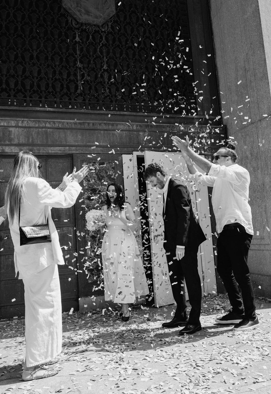 guests throwing confetti after an NYC city hall wedding ceremony