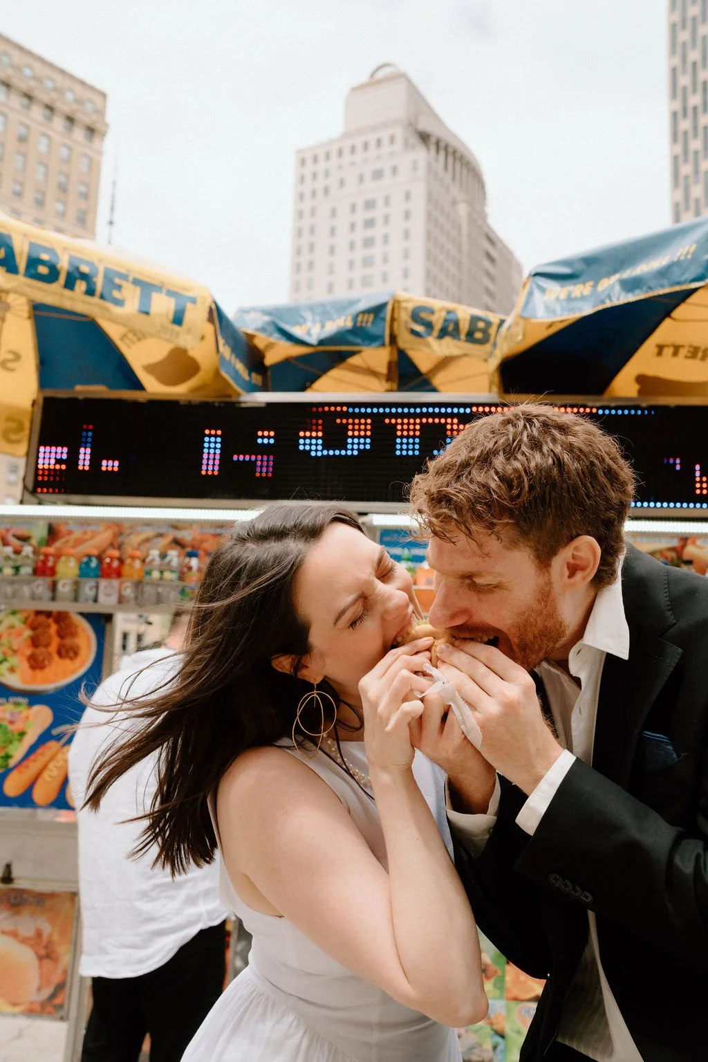 happy bride and groom eating hot dogs in new york city