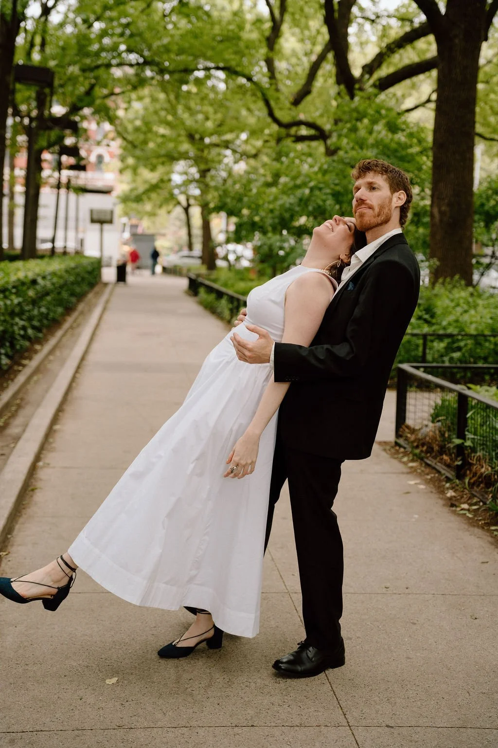 Bride and groom walking through a park after their NYC city hall elopement