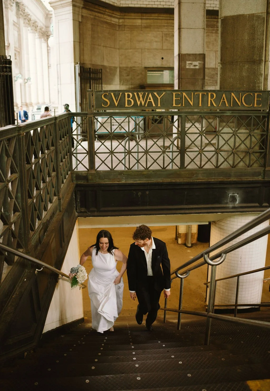 Bride and groom riding the New York City subway after their intimate wedding