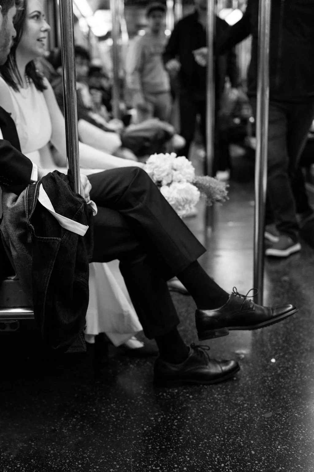 Bride and groom riding the New York City subway after their intimate wedding