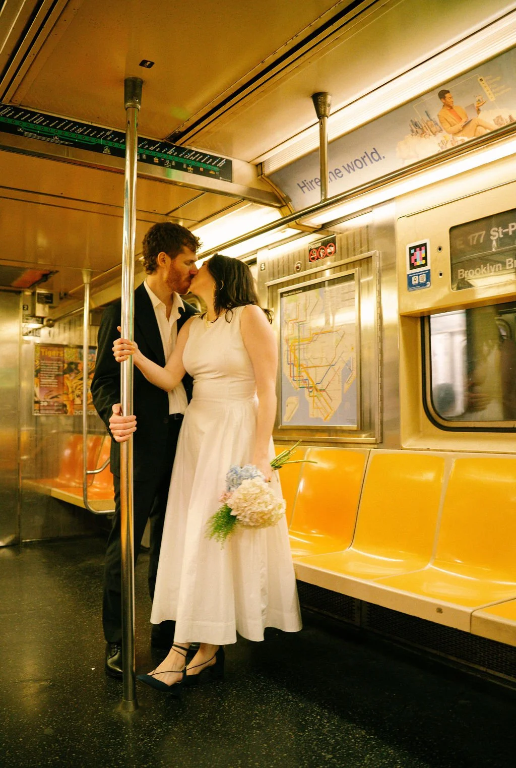 Bride and groom riding the New York City subway after their intimate wedding