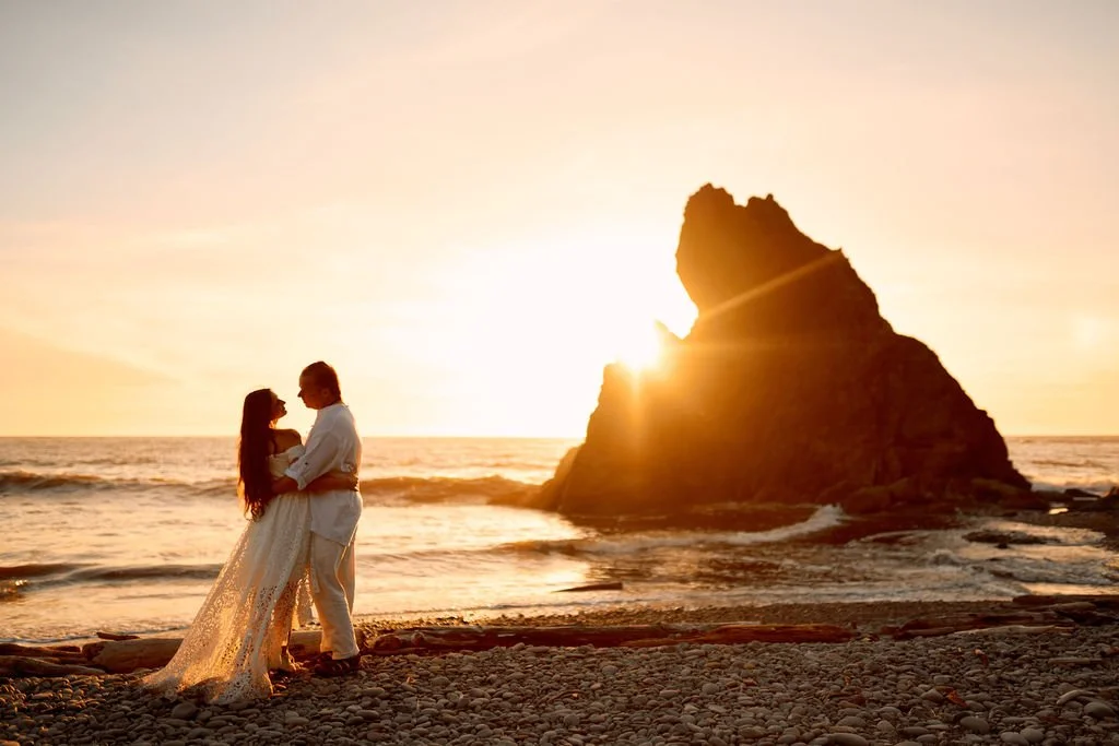 playful newlyweds along the coast of ruby beach during golden hour