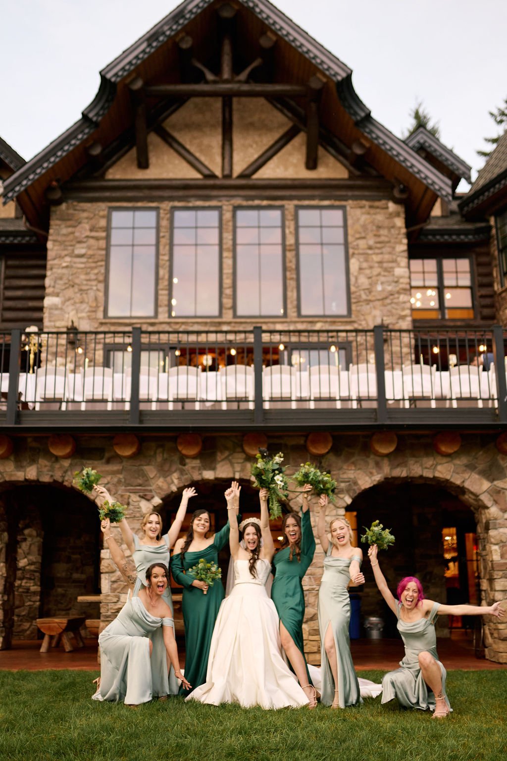 bride and the wedding party in front of The Castle at Summit Lake