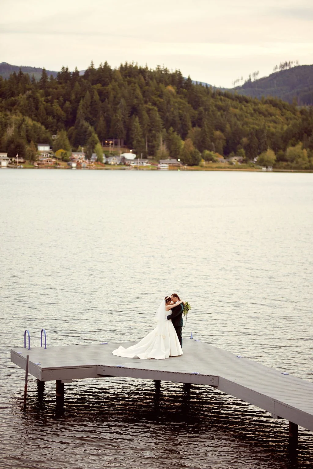 bride and groom on the lake dock during their olympia wa wedding day