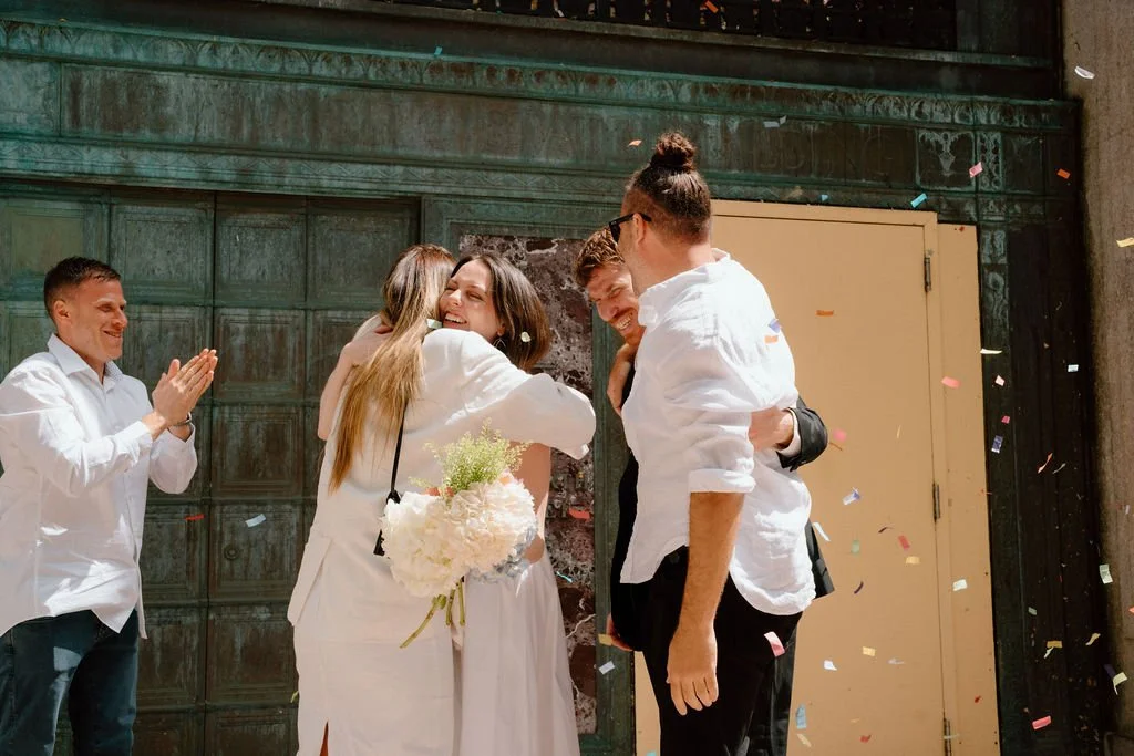 guests hugging couple after an NYC city hall wedding ceremony