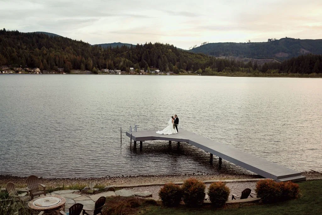 bride and groom on the lake dock during their olympia wa wedding day