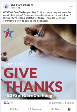 A person is writing on a white paper with a black pen. The background includes a wooden surface and a blue, red, and white star logo. The image promotes a self-care challenge with the message to give thanks.