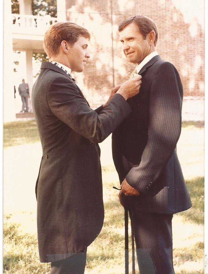 Dennis Calvin helping his dad JC fix his suit coat
