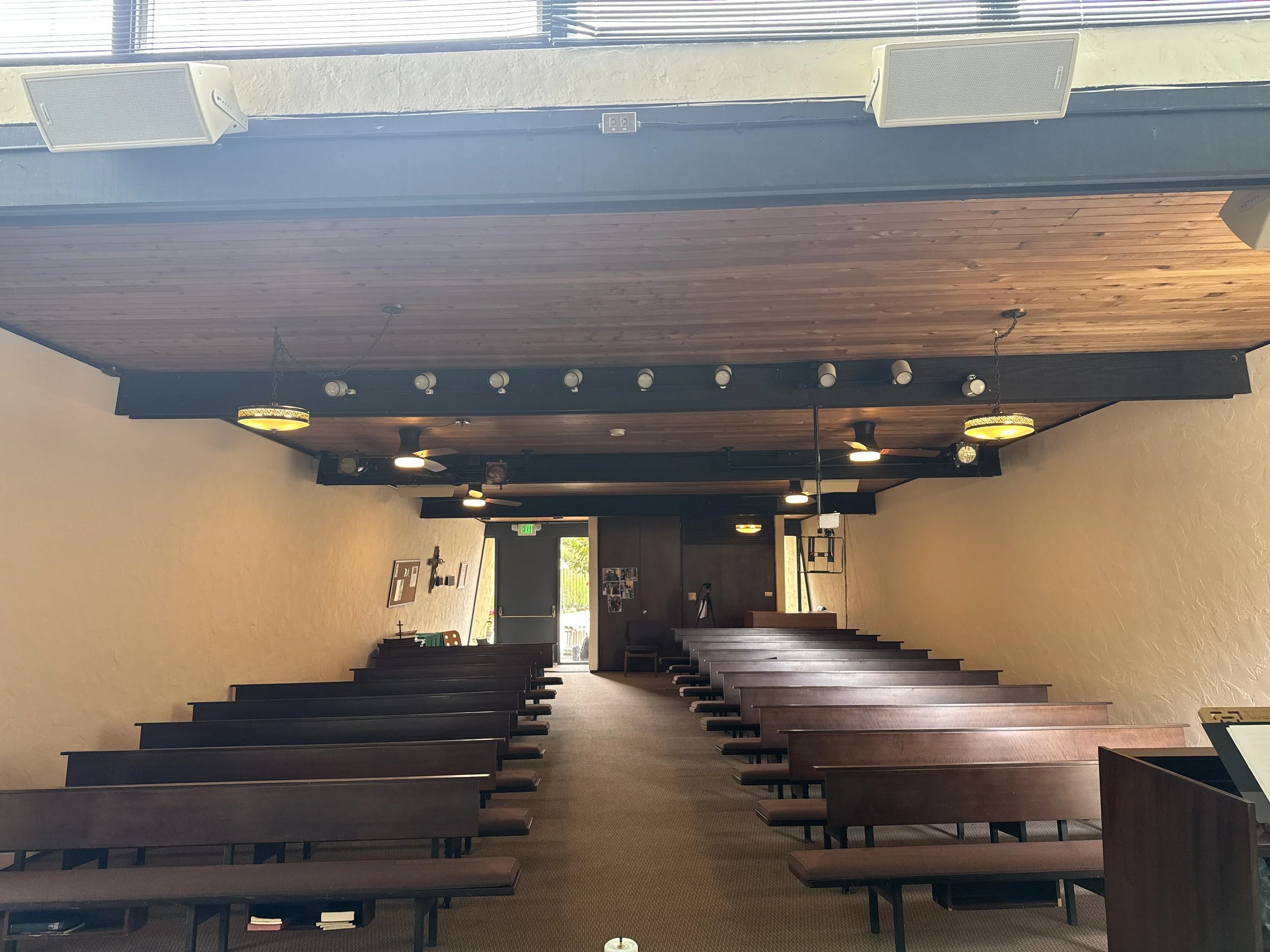 See the metal frame hanging above the 2nd row of pews? It is at eye level. That's an iPad mount, hanging in the middle of the sanctuary. 

It seems small in this photo, but in person, it is right in the way of much of the congregation.

This allowed 