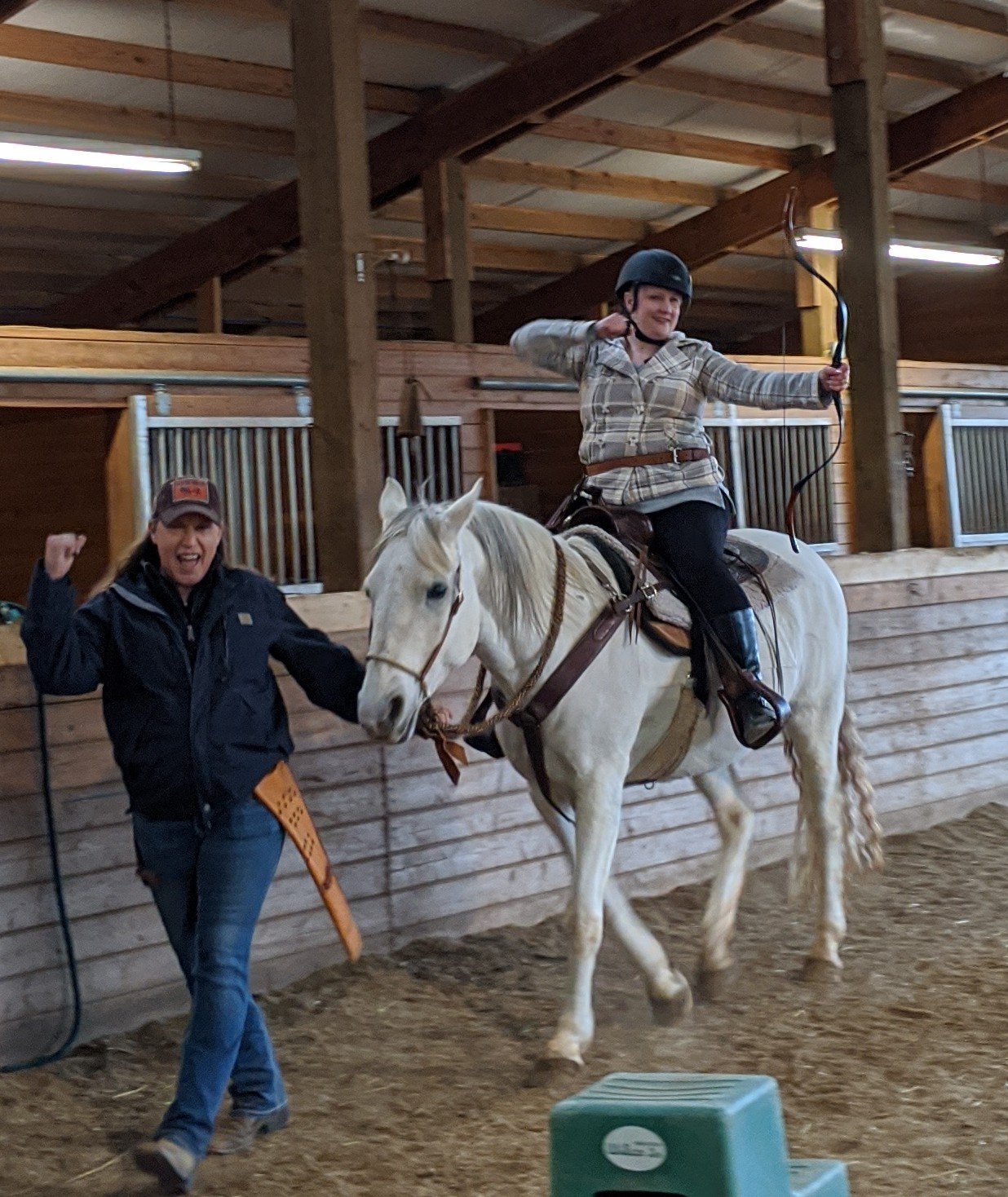 A client experiences mounted archery for the first time at a group workshop