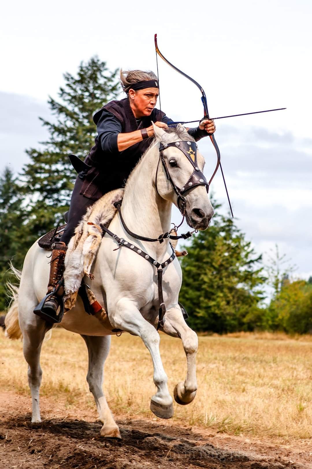 Meghan's mounted archery mentor, Lisa, shoots at a competition